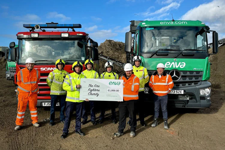 Firefighters and Enva staff pose with the £1k cheque.