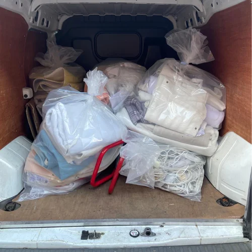 Damaged electrical blankeds packaged in bags in the back of a van
