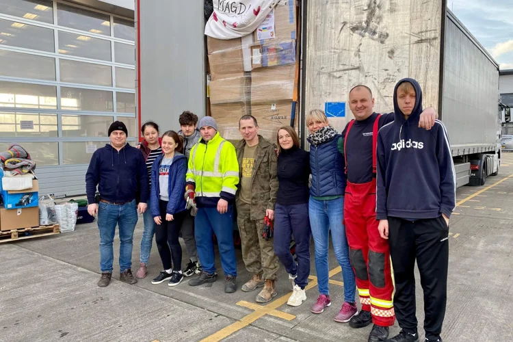 Group photo in front of a lorry with supplies destined for Ukraine