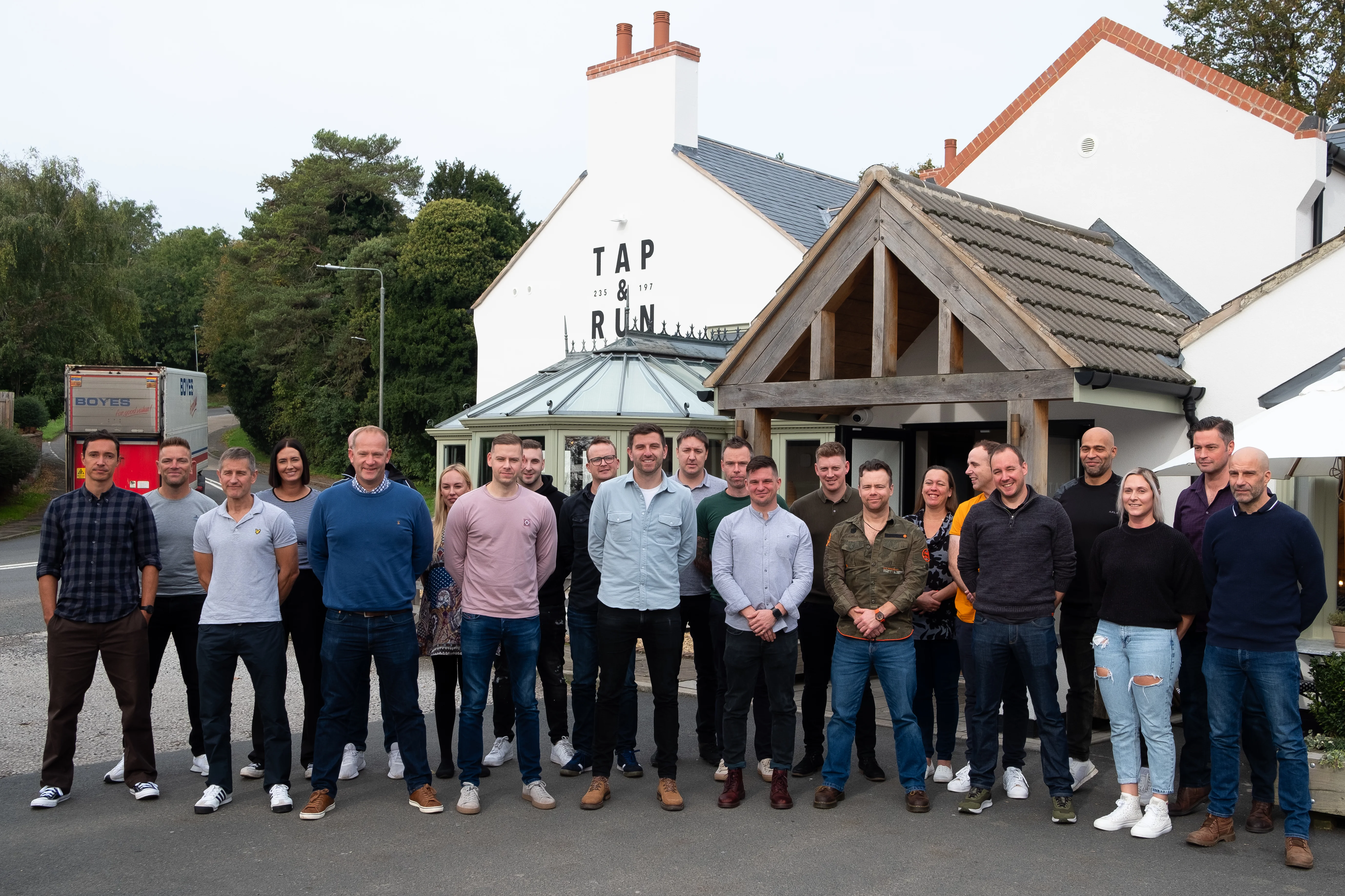 Group photo outside the tap and run pub