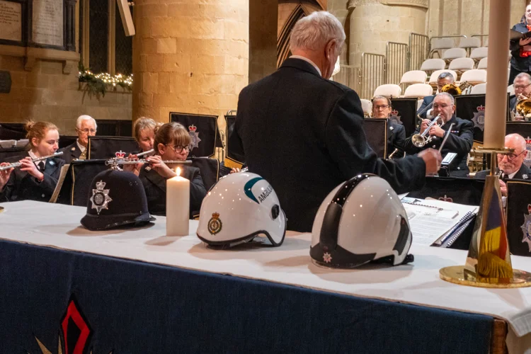 A police, ambulance and fire helmets on the altar at the joint carol service.