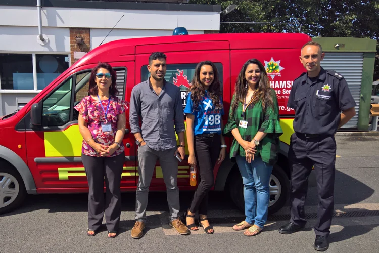 Group photo in front of a red fire service van