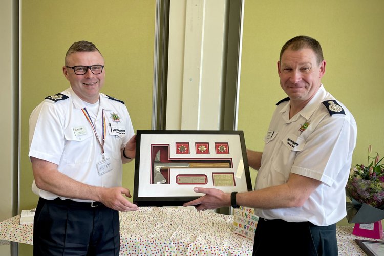 Craig Parkin presenting a plaque to Chief Fire Officer John Buckley