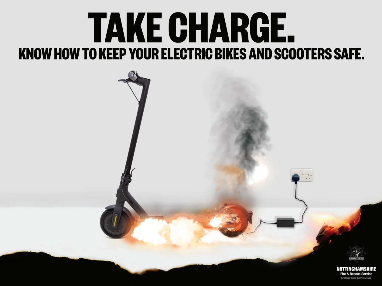 Safety poster showing an eScooter on fire with corners burnt. Poster reads "Take charge. Know how to keep your electric bikes and scooters safe."
