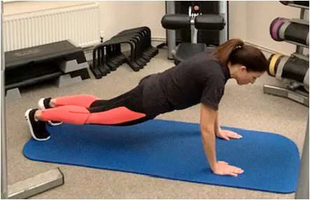 Demonstration of the starting plank position for a burpee