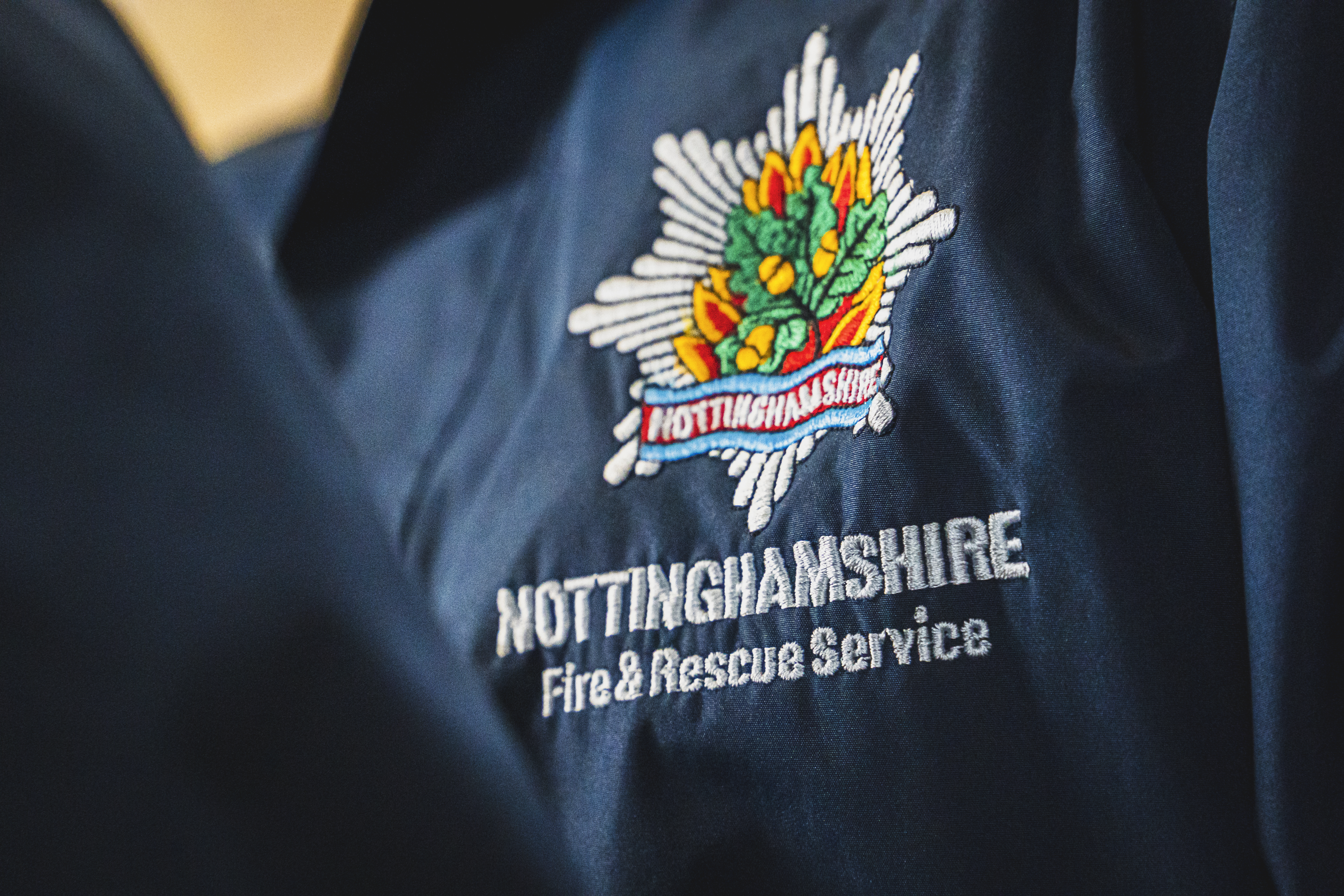 Nottinghamshire Fire and Rescue Service badge on coat.
