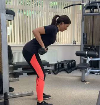 Bent over row viewed from the side with weights at waist height