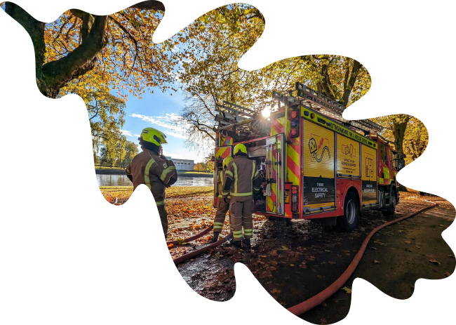 A fire engine by the side of a river inside an oak leaf shape