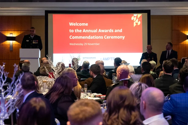 People watching a presentation from the chief at the awards night.