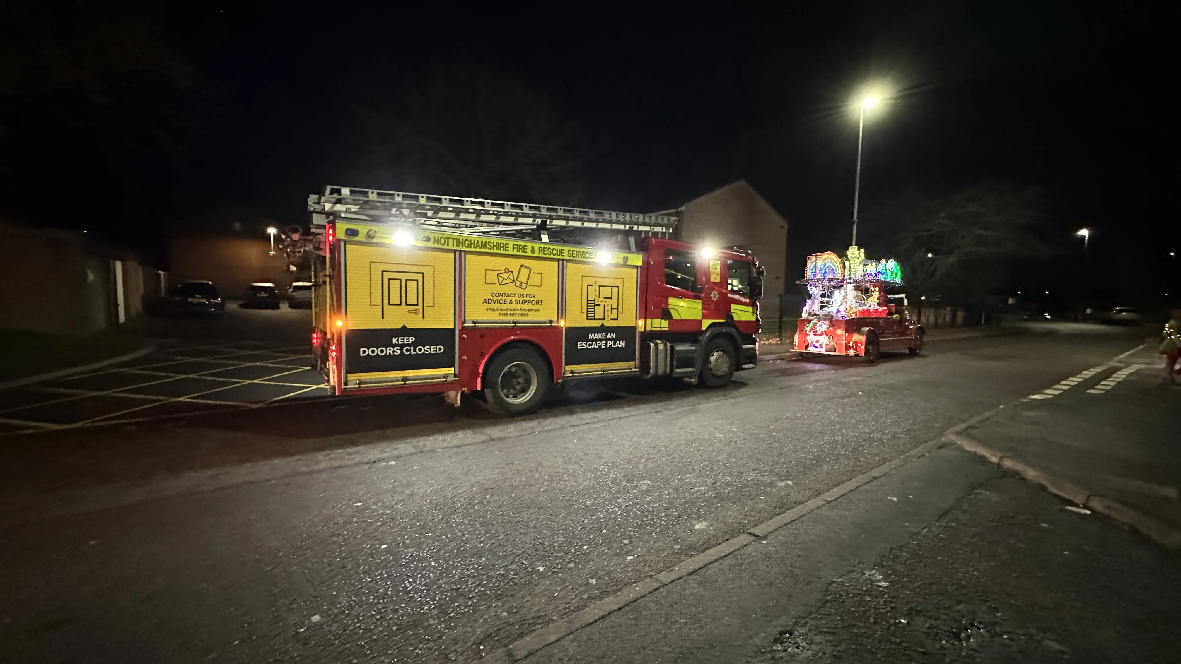vintage christmas fire engine with modern operational fire engine parked behind