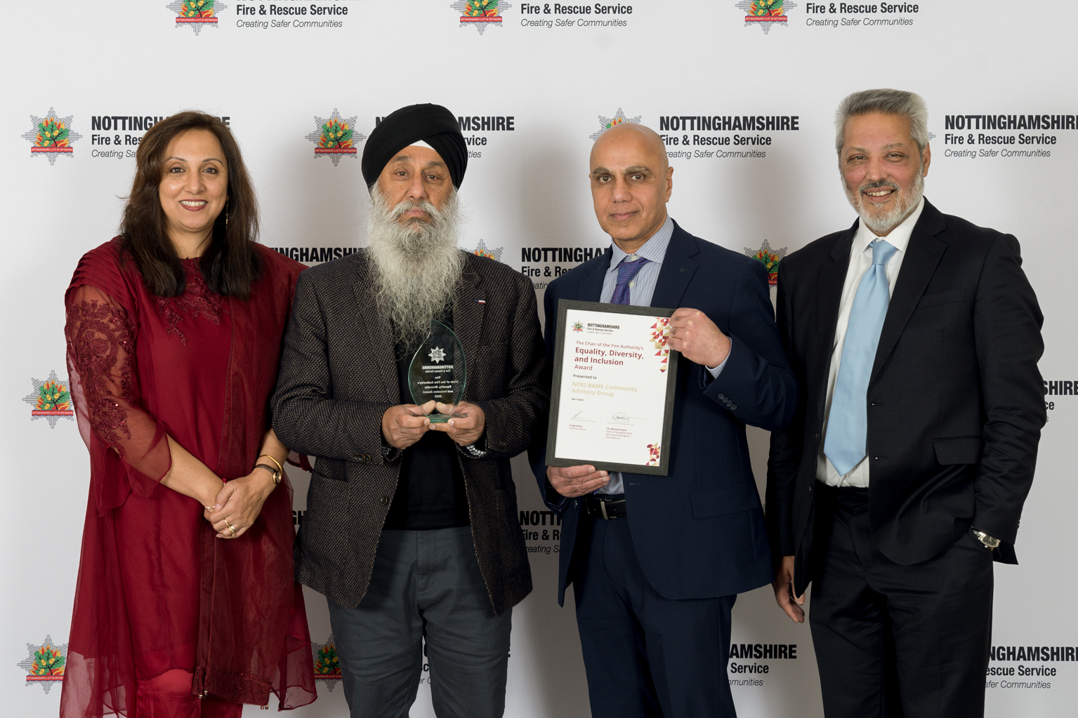 Four members of the BAME Community Advisory Group recieving an award for thier work supporting Nottinghamshire Fire and Rescue Service