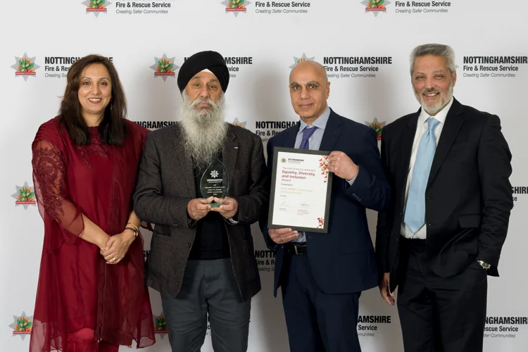 Four members of the BAME Community Advisory Group recieving an award for thier work supporting Nottinghamshire Fire and Rescue Service