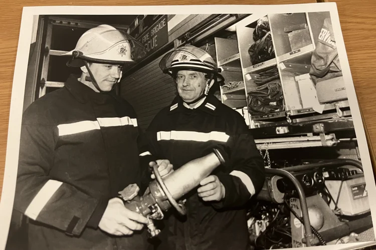 Black and white photo print of two firefighters
