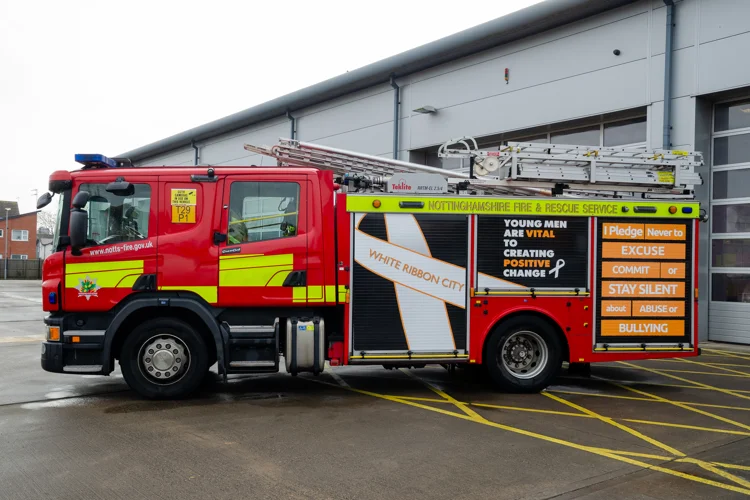 Highfields Fire Engine with new White Ribbon wrapping on seen from the side.
